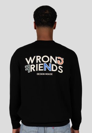 Black sweatshirt with white, blue, and orange embroidered text "WRONG FRIENDS DESIGN HOUSE" on back. Crew neck, long sleeves.