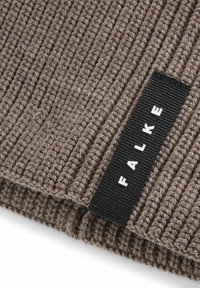 Tessuto a maglia a coste marrone con una superficie testurizzata; presenta un'etichetta in tessuto nera con lettere bianche che scrivono "FALKE."