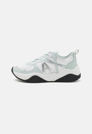 Light blue and white athletic shoes featuring silver accents, round toe, lace-up front, and a textured black rubber sole.