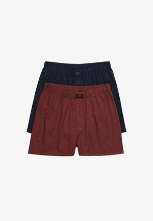 Deux paires de boxers pour hommes ; l'une marine et l'autre bordeaux. Les deux sont fabriqués en tissu doux avec des tailles élastiques et un détail de chapeau à un seul bouton.