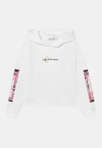 Sudadera blanca de Calvin Klein con el logo "CK Calvin Klein Jeans" en el pecho y parches gráficos florales rosas en ambas mangas.