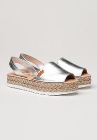 Sandalias de cuña plateadas con tira en el talón, punta abierta, plantilla de yute trenzado y suela de goma blanca, con un pequeño acento de logo.