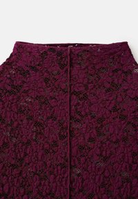 Burgundy lace skirt featuring floral patterns, a textured surface, and a back slit. The waistband is elasticated for added comfort.