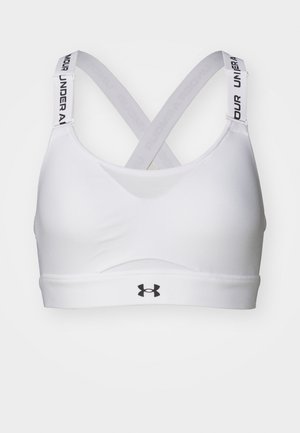 Hvit sports-bh med en jevn tekstur, kryssede stropper bak og en svart Under Armour-logo på frontbåndet. Enkelt design uten mønstre.
