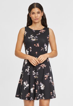 Schwarzes Blumenkleid mit ärmellosem Design, A-Linie Form und bunten Blumenmustern. Weicher Stoff mit rundem Ausschnitt und figurbetontem Oberteil.