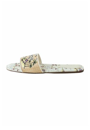 Flat slide sandal with beige woven strap featuring palm tree and beach umbrella embroidery, and a patterned footbed with beach illustrations.