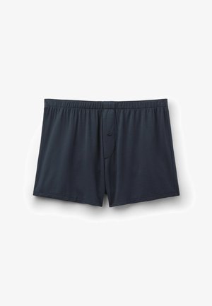 Męskie bokserki w ciemnym granatowym kolorze z elastycznym pasem i pojedynczym guzikiem na rozporku na białym tle.