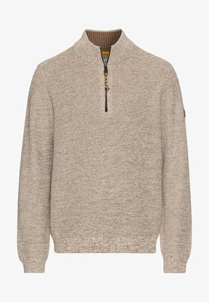 Beige sweater with a high collar and half-zip, featuring a textured knit pattern and ribbed cuffs. Small logo on the left sleeve.
