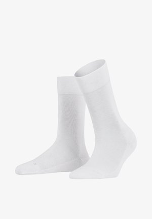 Calzini bianchi realizzati in tessuto traspirante, con una superficie liscia, lunghezza a metà polpaccio e design senza cuciture sulla punta per il massimo comfort.