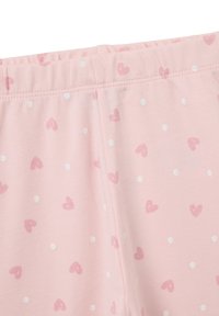 Leggings rosa claro con cintura elástica, que presentan un patrón repetido de pequeños corazones rosas y puntos blancos. Material de algodón suave.