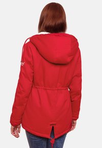 Red padded jacket with a hood, drawstring waist, and elastic cuffs. Features a logo patch and a rear vent for ventilation.