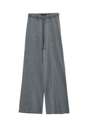 Pantaloni ampi grigi realizzati in tessuto morbido, con vita elastica e cordoncino, caratterizzati da dettagli delle cuciture sulla parte frontale.