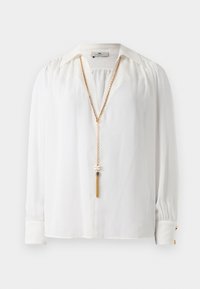 White long-sleeve blouse with gathered shoulders, pointed collar, buttoned cuffs, and a long gold chain necklace with tassel detail.