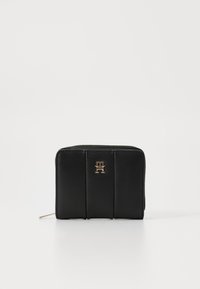 Black leather wallet with a zip closure, featuring quilted design and a gold logo on the front. Smooth texture and rectangular shape.