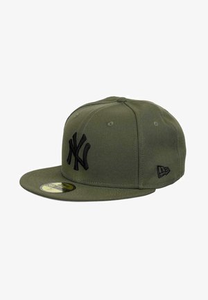 Olive green baseball cap made of fabric, featuring an embroidered black NY logo, flat brim, and six-panel design with ventilation eyelets.