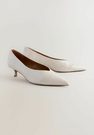 Hvide patentlæder spidse sko med en lav, slank hæl. Blank finish med en glat tekstur og raffineret silhuet.