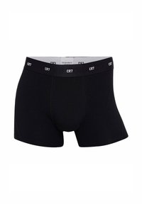 Boxer breve in cotone nero con un design aderente, caratterizzato da una texture liscia e un elastico in vita etichettato "CR7" in lettere bianche.