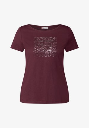 T-shirt bordeaux avec un col rond et des manches courtes. Présente un graphisme à pois argentés avec le texte "inspire-toi" au centre.