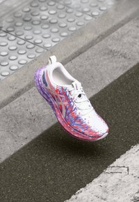 Lightweight running shoe with a white upper, purple and red graphic design, textured midsole, and a purple translucent outsole.