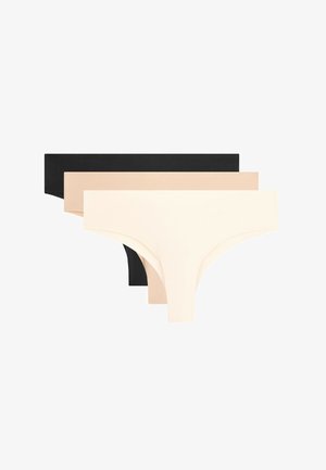 Tre slip perizoma senza cuciture impilati nei colori nero, beige e crema su sfondo bianco.