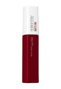 Le rouge à lèvres Maybelline SuperStay Matte Ink dans un tube bourgogne mat avec un capuchon blanc, présentant une forme rectangulaire élégante et un texte en relief.