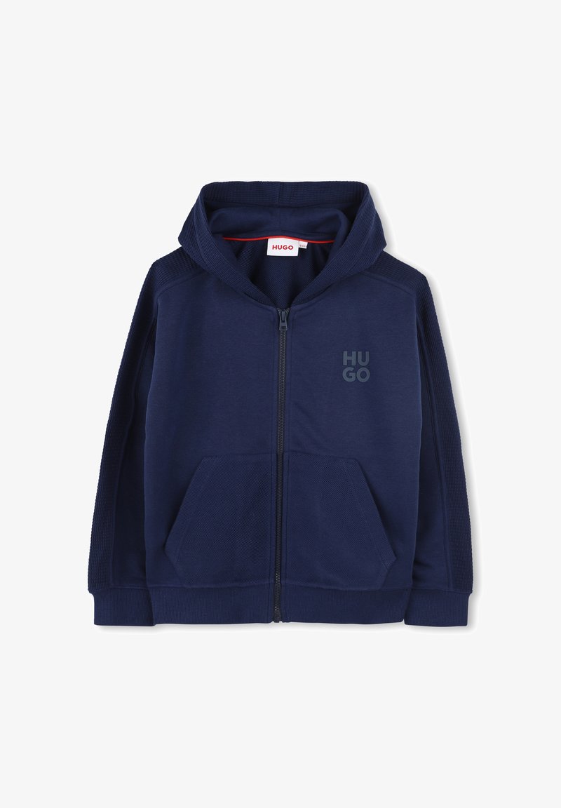 Veste à capuche zippée bleu marine en tissu doux, dotée d'une capuche, de poches avant et d'un logo "HUGO" ton sur ton sur la poitrine. Panneaux latéraux texturés.