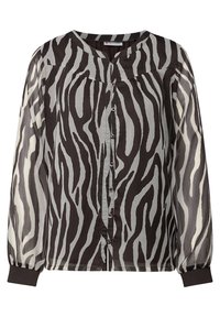 Blusa a righe zebrate in bianco e nero con maniche lunghe e trasparenti, scollatura tonda e chiusura frontale con bottoni colorati.