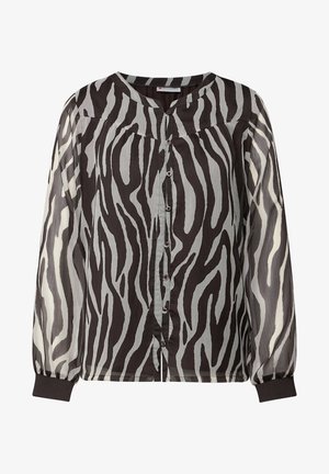 Blusa de estampado de cebra en blanco y negro con mangas largas y transparentes, escote redondo y frente abotonado con botones de color.