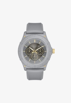 Gray silicone sports watch with a round face, black dial, gold accents, and three sub-dials. Features bold hour markers and textured bezel.