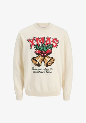 Krema pulover z pletenim vzorcem z napisom "XMAS" v rdeči barvi, božično zelenje in zvončki. Podpis pravi "Pošlji mi sporočilo, ko bo čas za božič."