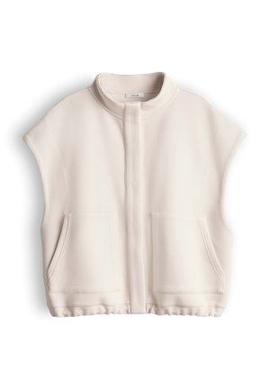 Veste sans manches crème à fermeture éclair avec col montant et deux poches avant, affichée à plat sur fond blanc.