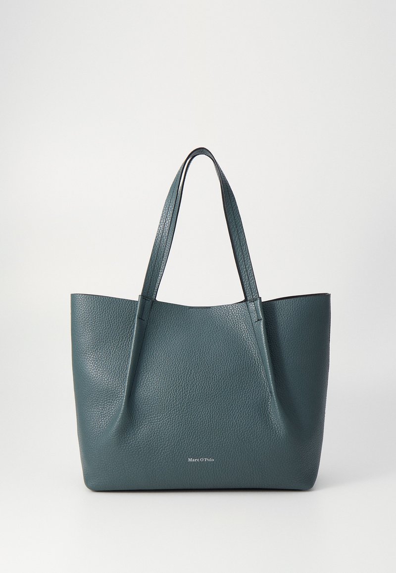 Teal leather tote bag with textured surface, two long handles, and a minimalist design. Features a visible brand logo at the bottom center.