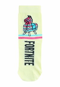 Kollane sokk, millel on pikseldatud roosa ja sinine piñata disain. "FORTNITE" on trükitud vertikaalselt paksus mustas kirjas külje peale.