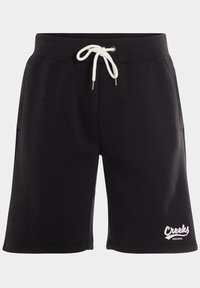 Pantalones cortos deportivos negros hechos de tela suave, con una cintura ajustable mediante cordón y bolsillos laterales. Logo "Creeks" visible en blanco en el dobladillo.