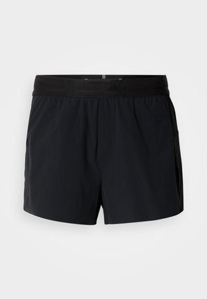 Pantaloncini sportivi neri con una ampia fascia elastica in vita, tasche laterali e tessuto leggero. Il design presenta una costruzione senza cuciture e materiale traspirante.