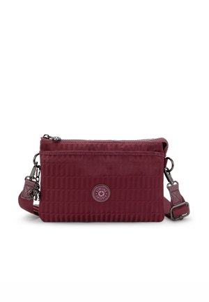 Burgundy crossbody bag with quilted texture, front zip pocket, adjustable strap, and logo detail. Made of durable fabric.