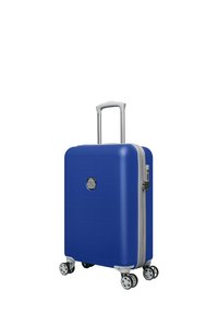 Blauwe harde koffer met hexagonaal patroon, zilveren rits, telescopische handgreep en vier multidirectionele wielen voor gemakkelijke mobiliteit.