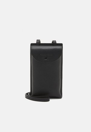 Small black leather crossbody bag with flap and snap button closure, thin adjustable strap, and textured surface on white background.