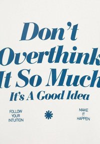 White fabric with blue typography: "Don't Overthink It So Much It's A Good Idea." Additional text: "Follow Your Intuition" and "Make It Happen."
