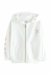 Valkoinen vetoketjuhuppari, joka on valmistettu pehmeästä kankaasta. Siinä on huppu, etutaskut, kullanväriset metalliosat sekä vaaleanpunaiset perhonen ja nauha -kuviot.