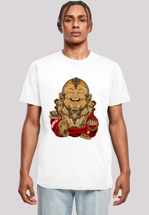 White t-shirt featuring a colorful graphic of a smiling, seated figure with a brown skin tone, adorned with jewelry and a red robe.