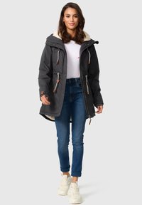 Gray parka jacket with a faux fur-lined hood, adjustable drawstrings, and toggle hardware. Paired with blue jeans and white sneakers.
