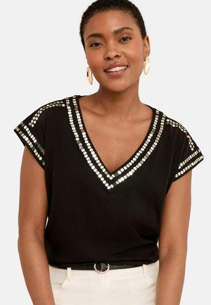 Black short-sleeve top with V-neck, featuring silver circular sequins along the neckline and shoulders. Smooth fabric and relaxed fit.