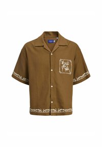 Chemise marron à manches courtes avec un devant à boutons. Dotée d'une broderie florale blanche sur la poche poitrine gauche et dans l'ourlet inférieur. Texture de tissu douce.