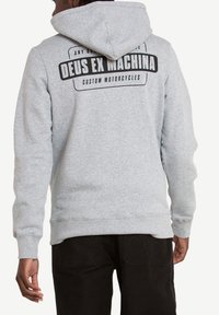 Sudadera gris con capucha; presenta un atrevido estampado negro que dice "DEUS EX MACHINA CUSTOM MOTORCYCLES" en la parte de atrás. Tejido suave, ajuste relajado.