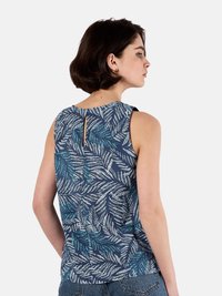 Top senza maniche blu navy con un motivo a foglie in verde e bianco, caratterizzato da un dettaglio a oblò sulla schiena e una silhouette rilassata.