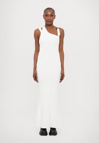 Ribbed white dress with an asymmetric neckline, featuring a shoulder strap accented by a metallic buckle and a long, fitted silhouette.