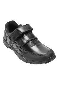 Baskets noires avec deux sangles Velcro réglables, tige synthétique lisse, col rembourré et semelle en caoutchouc texturé pour une meilleure traction.
