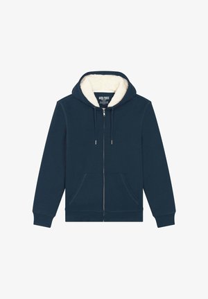 Sötétkék cipzáros kapucnis pulóver fehér, bolyhos béléssel a kapucniban, állítható zsinórokkal és elülső zsebekkel. Puha tapintás, laza dizájn.