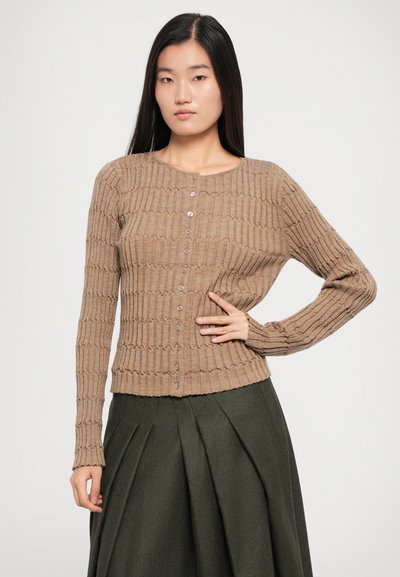 Brown ribbed cardigan with a round neckline and long sleeves, featuring buttons down the front and a textured finish.